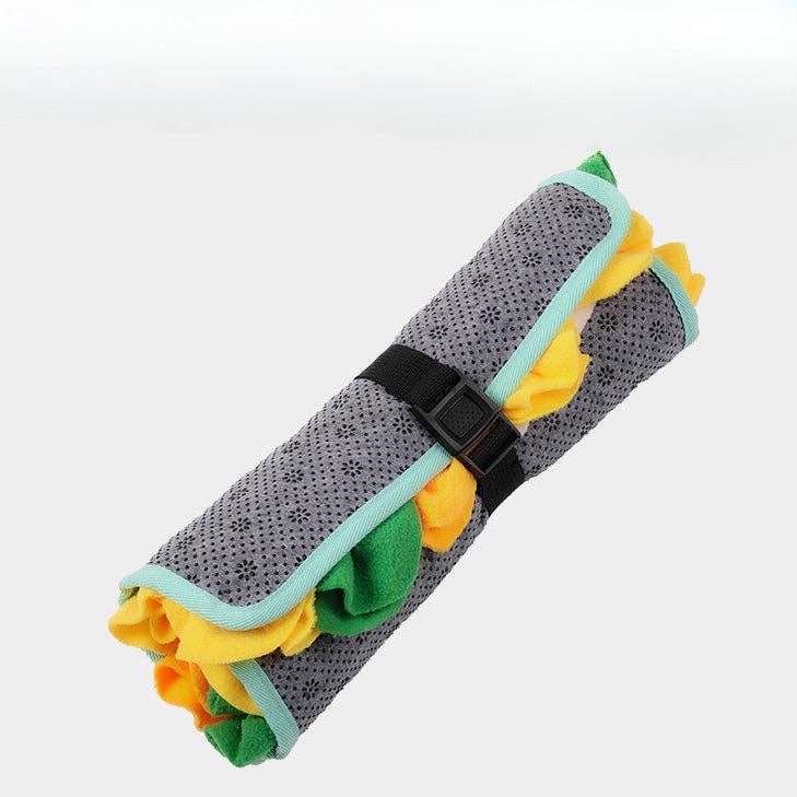 Barking Gardener collapsible snuffle mat for dogs rolled up with a black strap, featuring grey, yellow, and green felt.