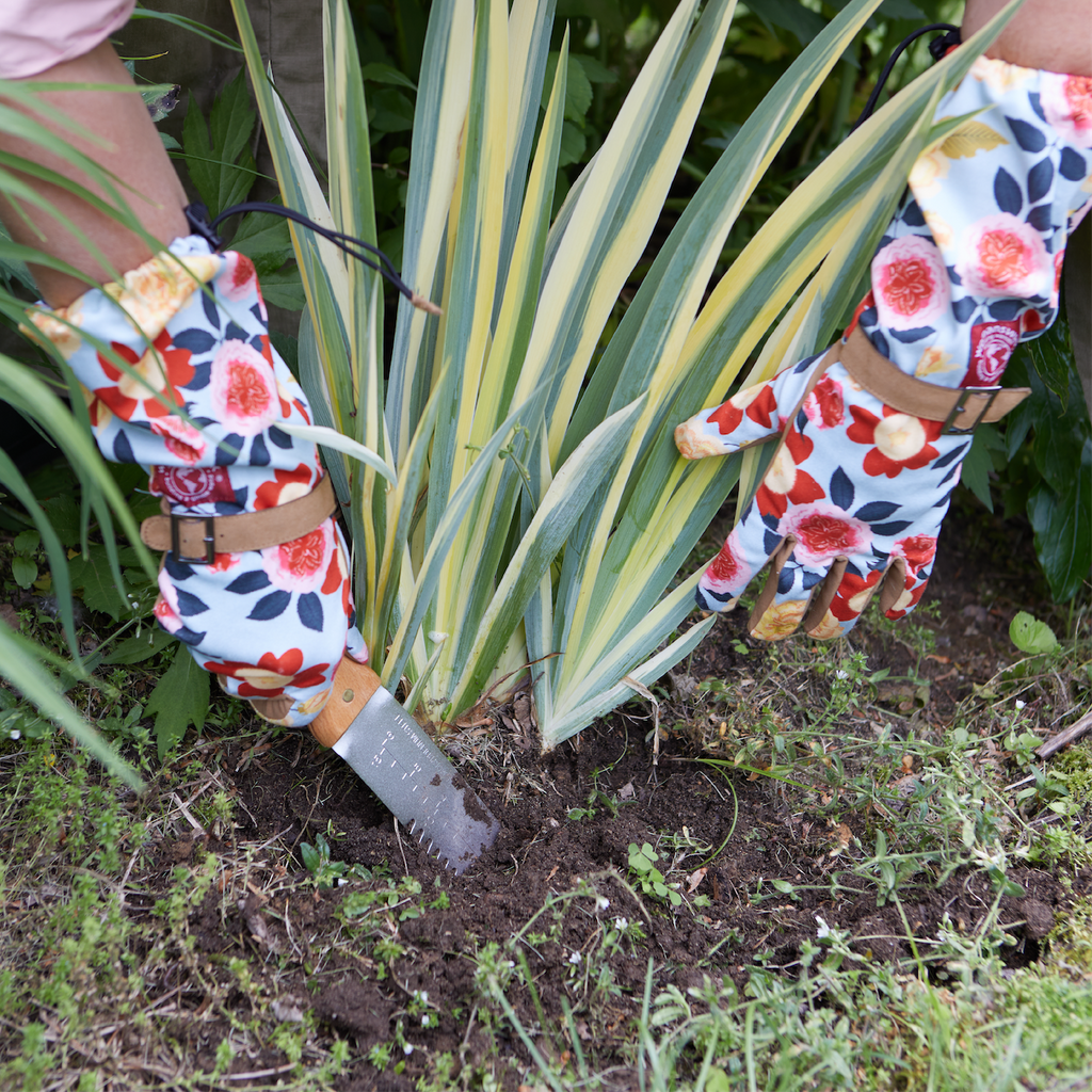 Barking Gardener Arm Saver Gloves with floral print, long cuffs, and synthetic leather palms digging in garden soil.