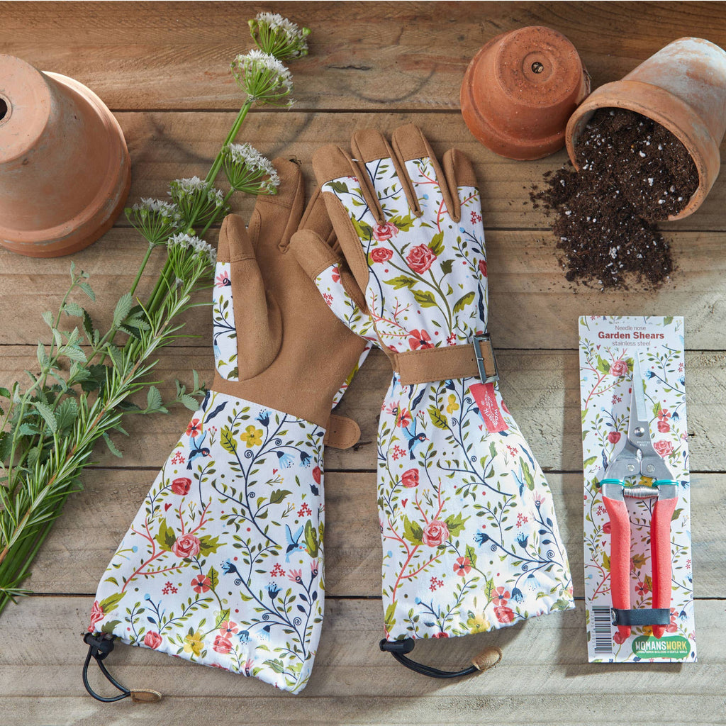 Barking Gardener floral arm saver gloves and stainless steel compact garden shears on a rustic wooden surface.