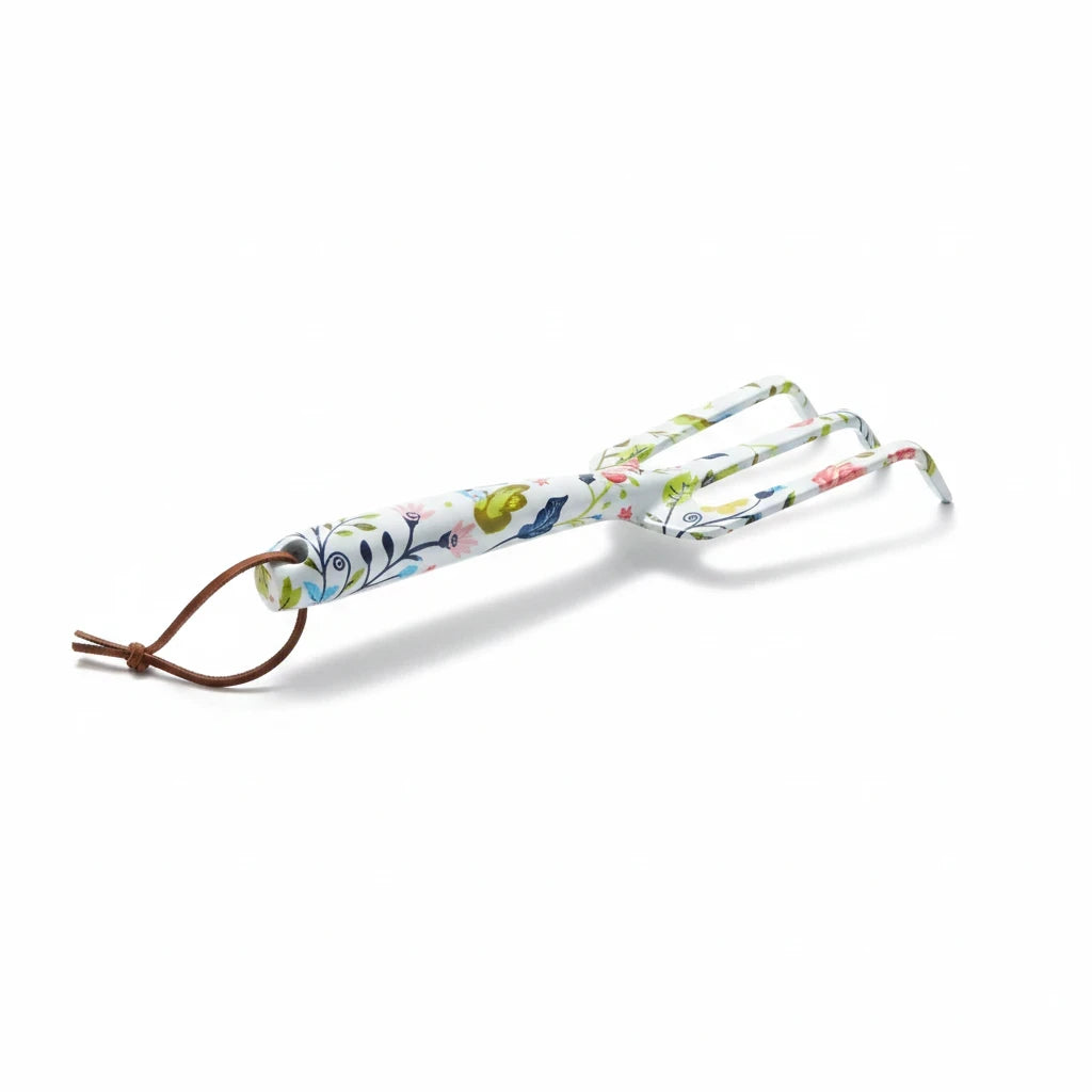 Barking Gardener floral patterned metal hand cultivator with a brown leather hanging loop on a white background