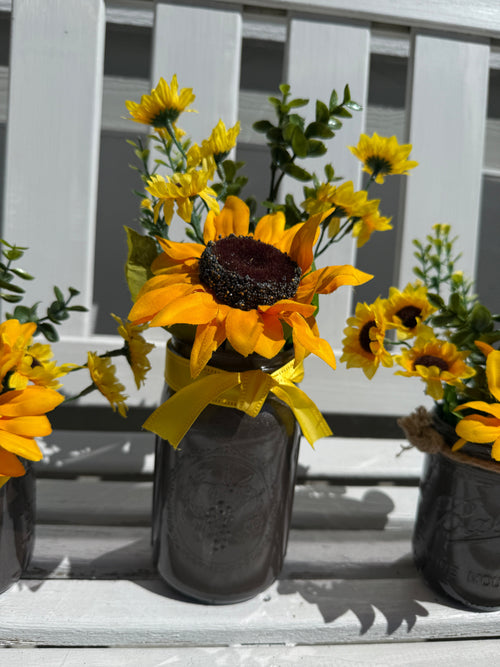 Barking Gardener farmhouse faux sunflower arrangement in a dark painted mason jar with a yellow ribbon bow